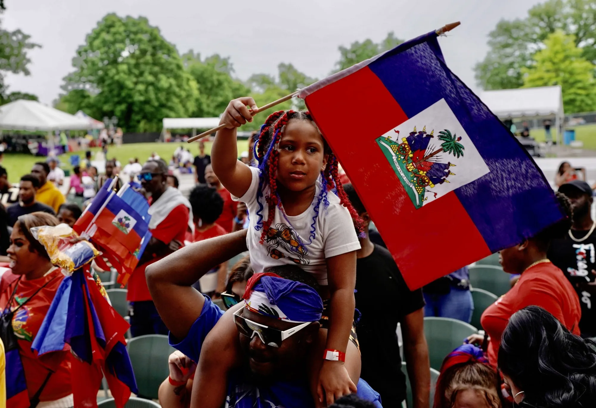 Haitian community celebrating heritage with the national flag